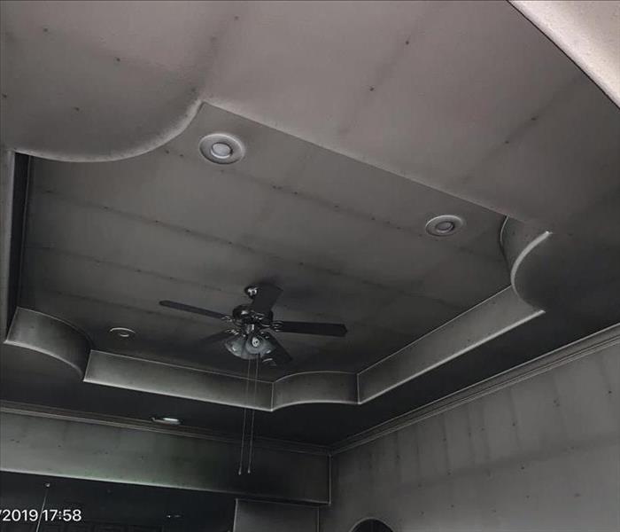 ceiling of a home affected with remaining Soot from a fire.